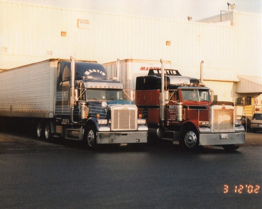 Martin semi trucks docked at warehouse transport services building on 03/12/2002.