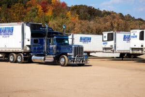 Martin transport services refrigerated trailer semi truck in Wilton, WI during Fall.